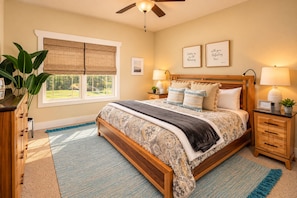A bedroom with a large bed, bedside lamps, a window with blinds, and two framed quotes on the wall. - Immaculate Cottage, Clean Hot Tub, 2 Miles to Asheville (Asheville)