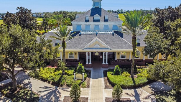 A large, yellow building with a central entrance, surrounded by well-maintained gardens and palm trees. - JUST LISTED! Heaven On Earth! Dis/Reunion. Gorgeous, Spacious, 8 Pools, Slps 10 (Kissimmee)