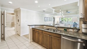 A modern kitchen with granite countertops, stainless steel appliances, and wooden cabinets. - JUST LISTED! Heaven On Earth! Dis/Reunion. Gorgeous, Spacious, 8 Pools, Slps 10 (Kissimmee)