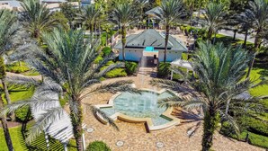 A resort with a central pool, palm trees, and a building with a blue roof. - JUST LISTED! Heaven On Earth! Dis/Reunion. Gorgeous, Spacious, 8 Pools, Slps 10 (Kissimmee)
