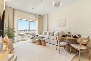 Luxury Apartment, Balcony, City View | Living area | 65-inch Smart TV with cable channels