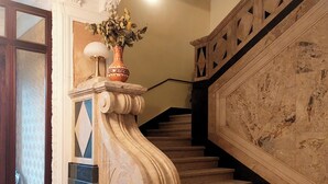 A grand staircase with marble steps and a decorative balustrade.