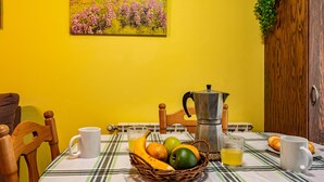 A breakfast table with a basket of fruit, a coffee pot, and a mug. - Apartment 'La Viña 2' with Mountain Views and Wi-Fi (Corao)