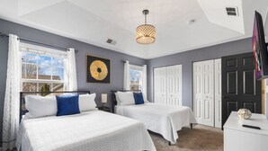 A bedroom with two beds, a chandelier, a wardrobe, and a TV. - Luxury 4 Bedroom Home Elgin (Elgin)