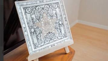 A framed artwork on a wooden easel.