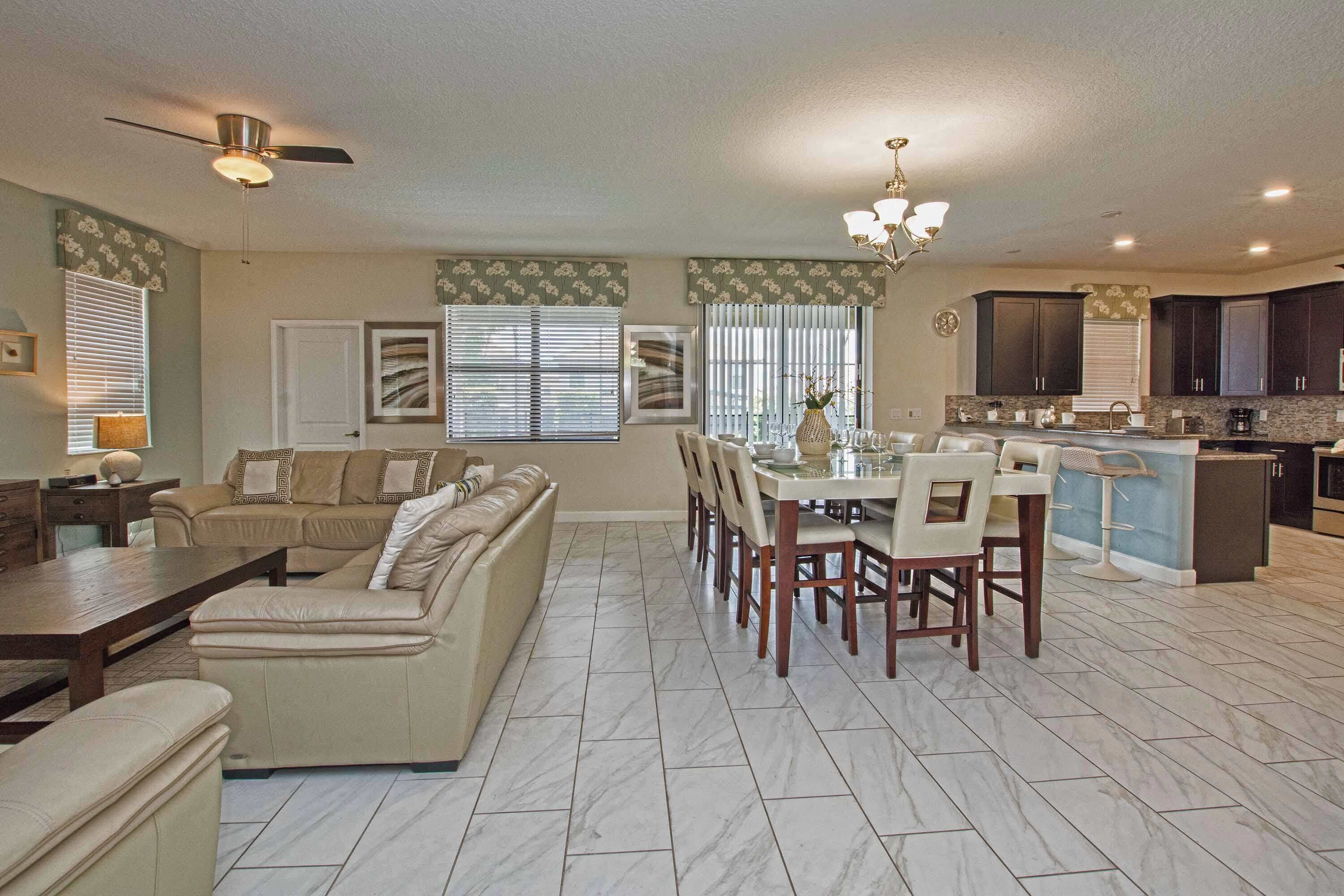 A spacious living area with a sofa, dining table, and kitchen.