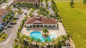 A large house with a swimming pool, surrounded by palm trees and a well-maintained lawn. - Family Getaway, 4BR Home Near Disney (Kissimmee)