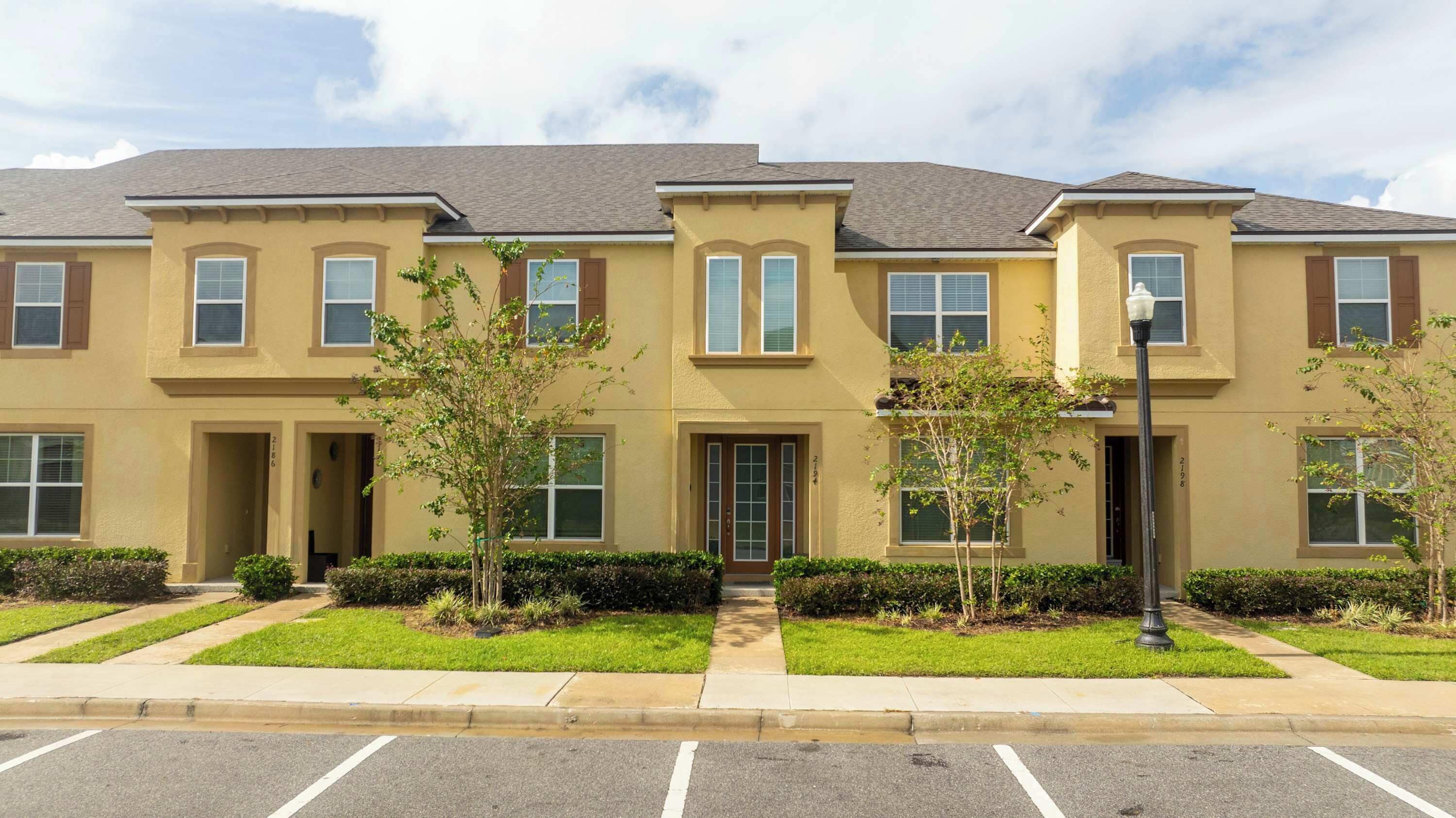 A multi-story residential building with a symmetrical facade, multiple windows, and a central entrance.
