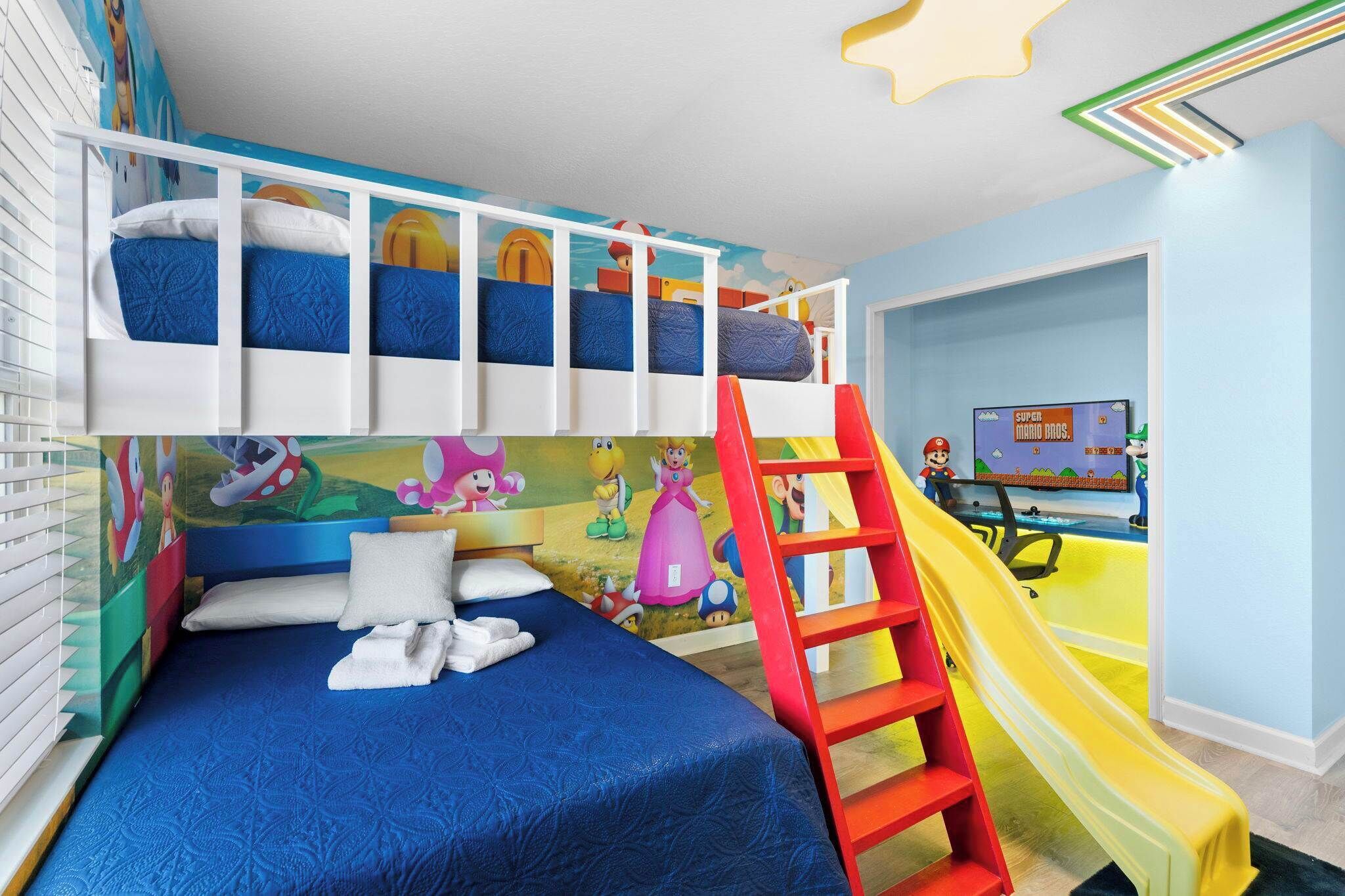 A child's bedroom with bunk beds, a slide, and a Mario-themed wall.