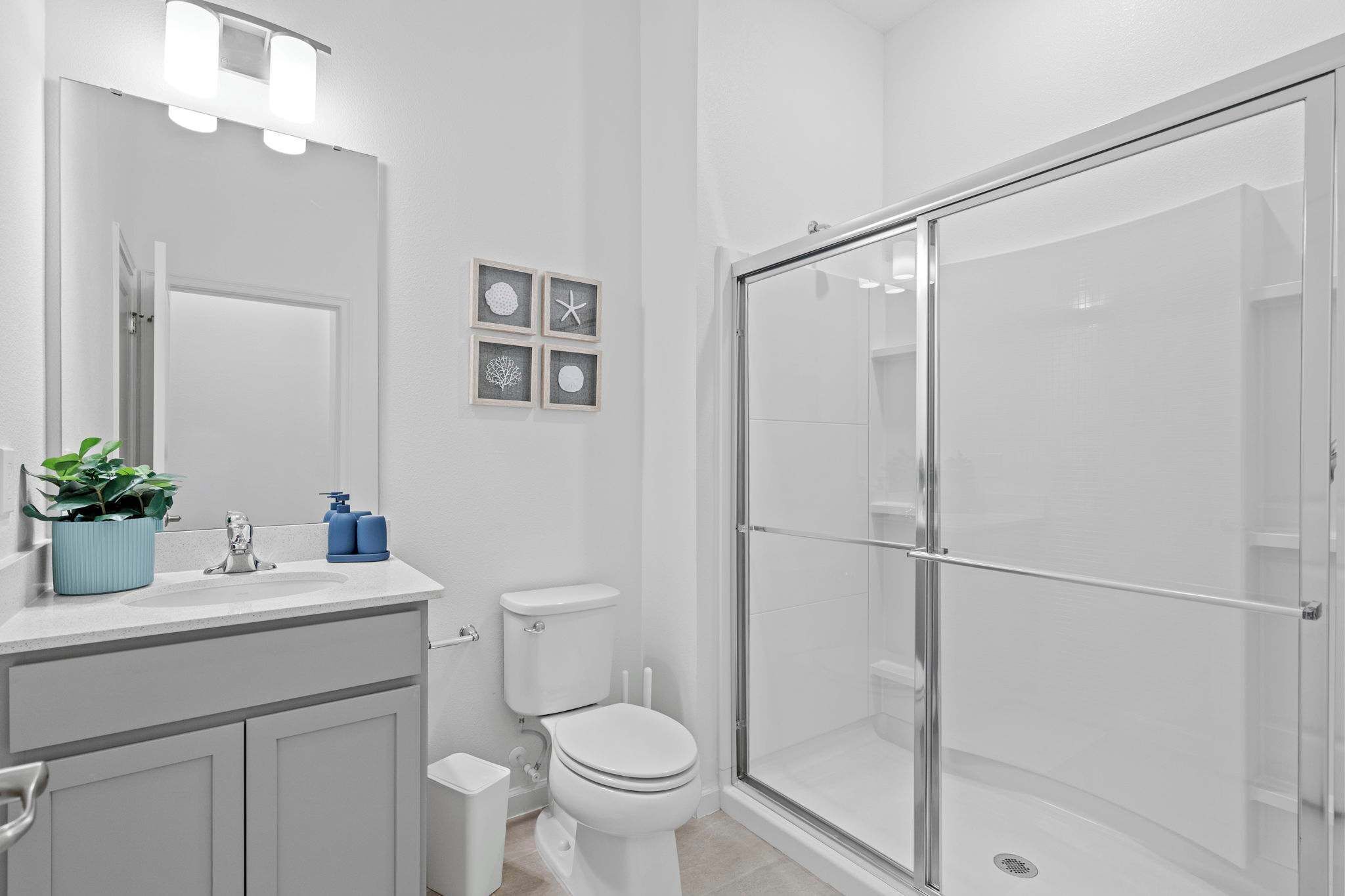 Une salle de bain avec des toilettes, un lavabo et une douche.