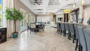 A spacious hotel lobby with a reception desk, bar area, and seating. - Private Pool at Solterra 4BR Townhome (Davenport)