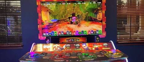 A gaming arcade with a Minecraft-themed screen and multiple card redemption machines.