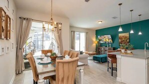 A modern kitchen with a bar area, dining space, and a view of the city. - Vacation Bliss-prime Resort, Unbeatable Location (Kissimmee)