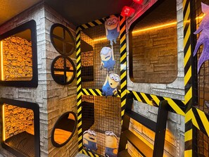 A play area with circular openings and a netted climbing structure. - Last Minute Disney Getaway! Luxury Villa with Private Pool, Game Room & Themed Bedrooms. Book Now! #138193 (Orlando)