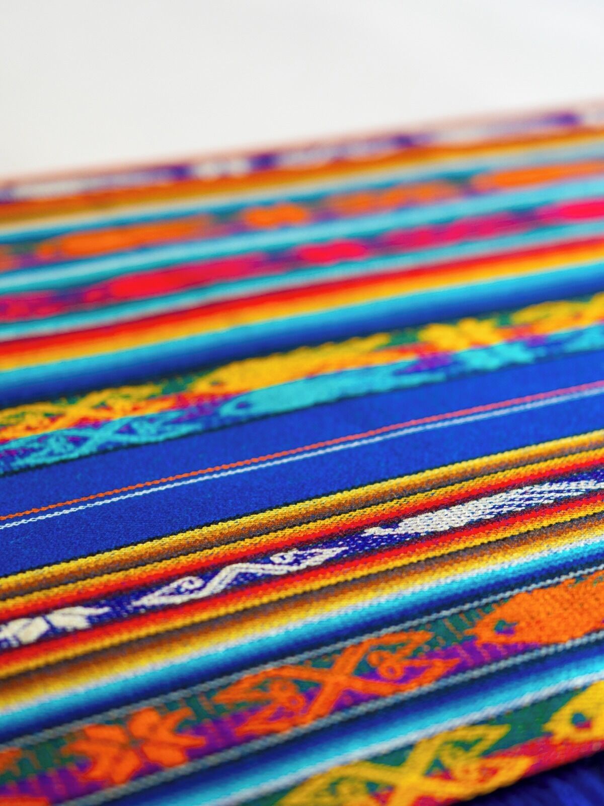 A close-up of a colorful woven textile with intricate patterns.