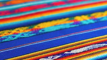 A close-up of a colorful woven textile with intricate patterns.