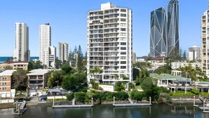 A high-rise hotel with multiple floors, a waterfront view, and a modern architectural design. - Palms on Gold Riverfront Haven by Gold Coast Beach (Surfers Paradise)