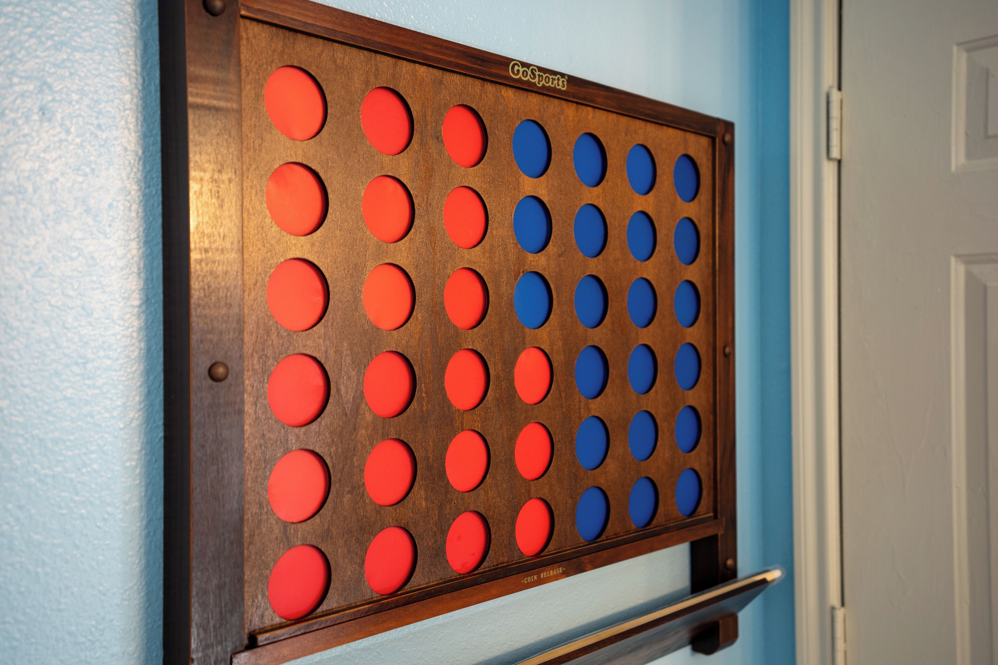 A GoSports game board mounted on a wall.