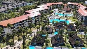 A resort with multiple buildings, a central pool area, and surrounding greenery. - Marulhos Suítes Resort (Ipojuca)