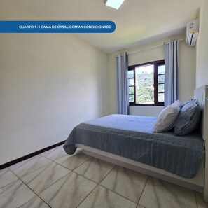 Camera singola di dimensioni uguali, con un letto singolo, una finestra con tende e un termosifone.
