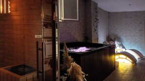 A modern bathroom with a wooden vanity, a large bathtub with a built-in shower, and a mirror above the sink. - Fabiola Guest House (Pompei)