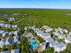 A residential area with houses, a swimming pool, and a forested landscape. - 30A Escape,  close to Beach Access and Epic Pool (Santa Rosa Beach)