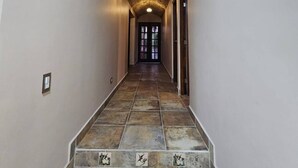 A hallway with a herringbone patterned ceiling and a tiled staircase with decorative tiles. - Flor del Desierto - Lovely house with cool AC in vibrant LORETO, BCS (BCS)