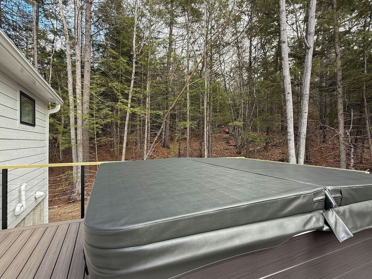 A covered outdoor deck with a mattress.