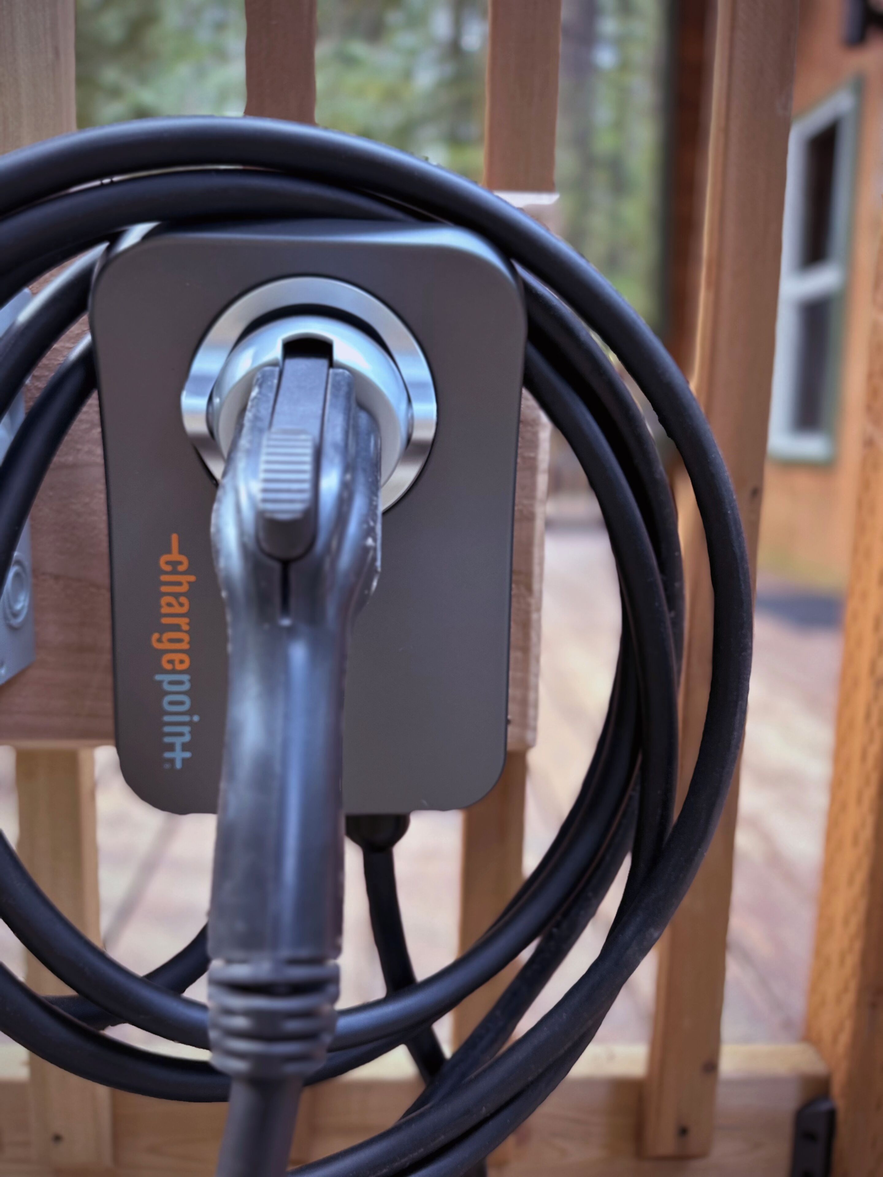 Een close-up van een oplaadstation met een aangesloten kabel.