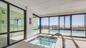 Un espace piscine avec un panneau indiquant une profondeur de 3 pieds, de grandes fenêtres et une vue sur la piscine.