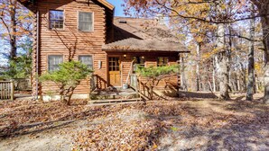 A rustic log cabin with a front porch and a small garden area. - On-Site Trails, Pond! Rustic Harpers Ferry Cabin (Harpers Ferry)