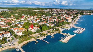 An aerial view of a coastal town with residential buildings, a marina, and a beach. - Stunning apartment in Turanj with house sea view (Turanj)