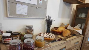A kitchen counter with various food items, jars of preserves, and a Nutella jar. - Farmhouse in typical Trentino style, spacious, elegant, comfortable. (Civezzano)