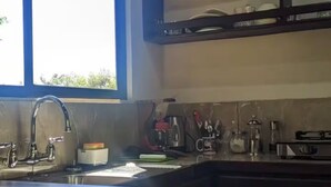 A kitchen with a window, a sink, and a countertop. - villas tucan (Santa Elena)