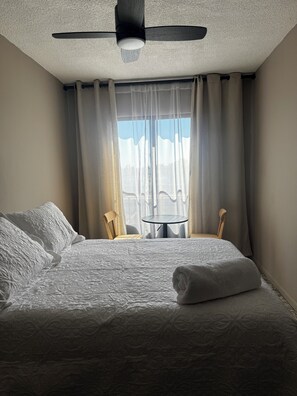 Desk, laptop workspace, blackout curtains, iron/ironing board