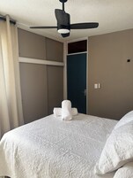 Desk, laptop workspace, blackout drapes, iron/ironing board