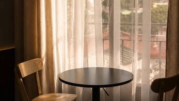 Desk, laptop workspace, blackout drapes, iron/ironing board