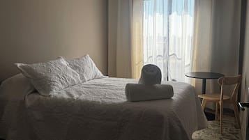 Desk, laptop workspace, blackout curtains, iron/ironing board