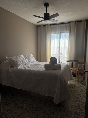 Desk, laptop workspace, blackout curtains, iron/ironing board