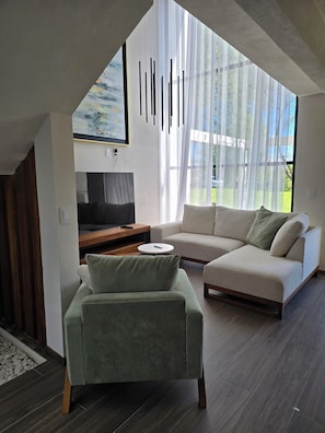 Living area - Casa Olivo with double height living room, surrounded by a large garden. (Ixmiquilpan)