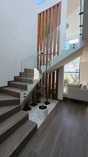 Casa Olivo with double height living room, surrounded by a large garden.