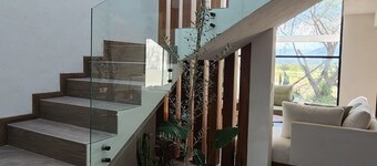 Casa Olivo with double height living room, surrounded by a large garden.