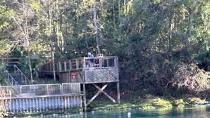 A wooden dock with a viewing platform, surrounded by trees and clear water. - Fabulous private RV pad with full hookups, sewer and water located in Old Town (Old Town)