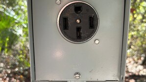 A utility box with a power outlet and a conduit pipe. - Fabulous private RV pad with full hookups, sewer and water located in Old Town (Old Town)
