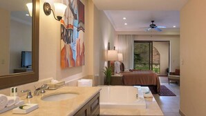 A hotel room with a large bathroom vanity, a bed with a view, and a balcony. - 2-bedroom resort in fantastic Loreto with AC and fitness room (Loreto)