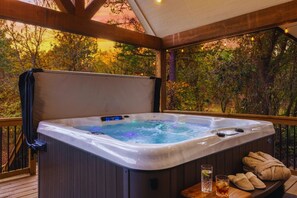 A hot tub on a wooden deck with a view of trees. - Cozy Retreat |  Pool Table, PingPong, Playset (Broken Bow)