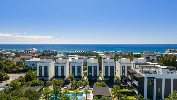 A coastal hotel with modern architecture, a swimming pool, and a view of the ocean. - Rooftop Deck w/ Gulf Views, Game Room Modern 30A by Avantstay (Santa Rosa Beach)