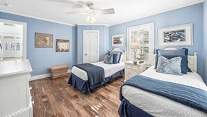 A bedroom with two beds, a ceiling fan, and framed pictures on the walls. - Sunshine, Seaside and Nobellah's Retreat/ Pet Friendly/ 4 Bikes (Santa Rosa Beach)