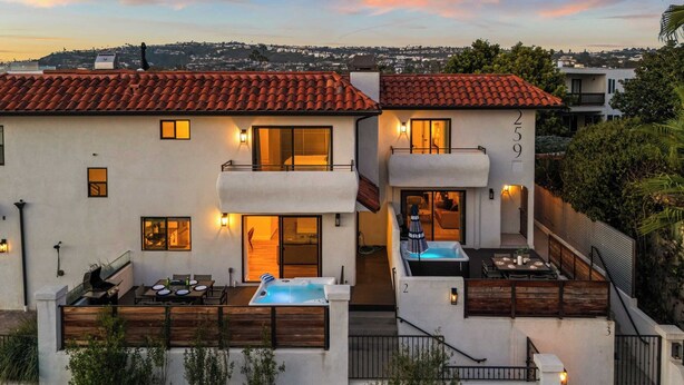 A two-story house with a red-tiled roof, a swimming pool, and a patio with outdoor seating. - Walk to Beach Hot Tub + Oceanview Deck 259 Trailhead Trestles 2 by Avantstay (San Clemente)