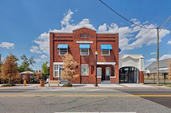 A red brick building with a sign reading 'Layton L. Pratt' and a number '525' on the front.
